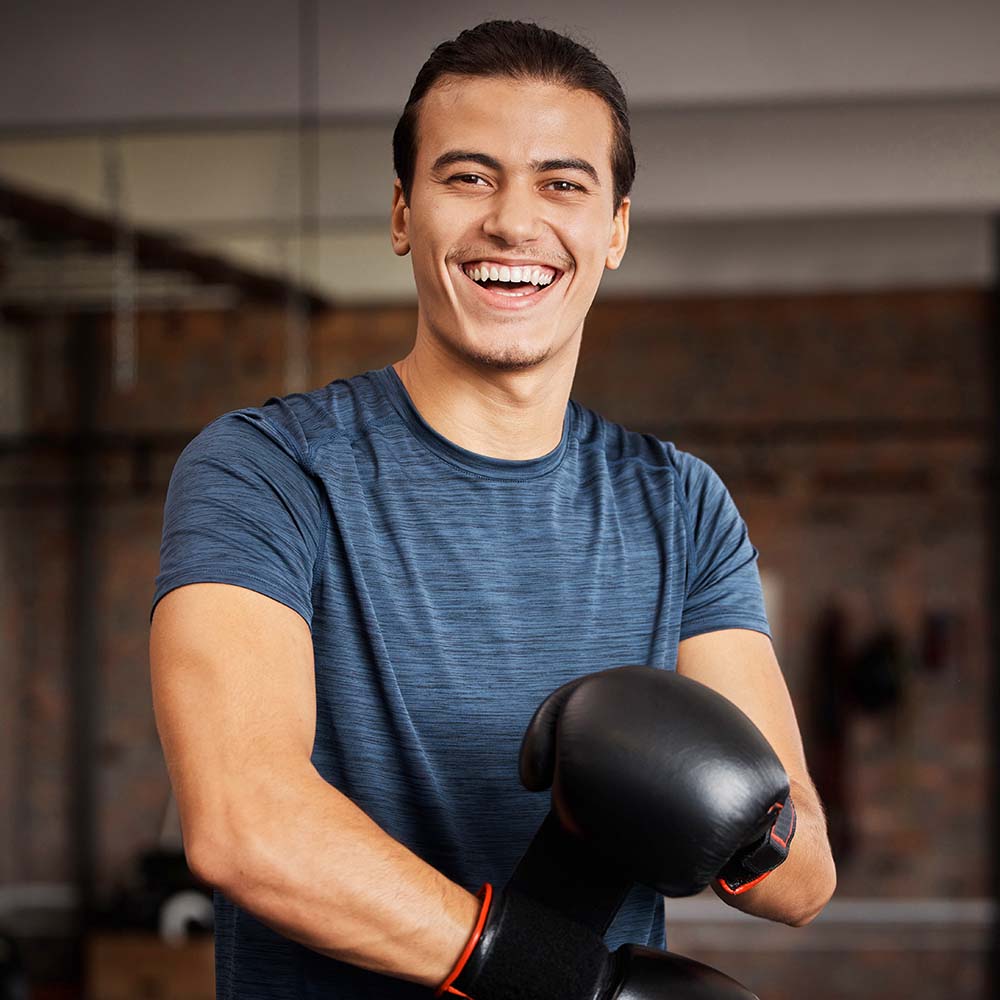 fitness-portrait-and-man-with-boxing-gloves-in-gy-EZ3MGGE.jpg